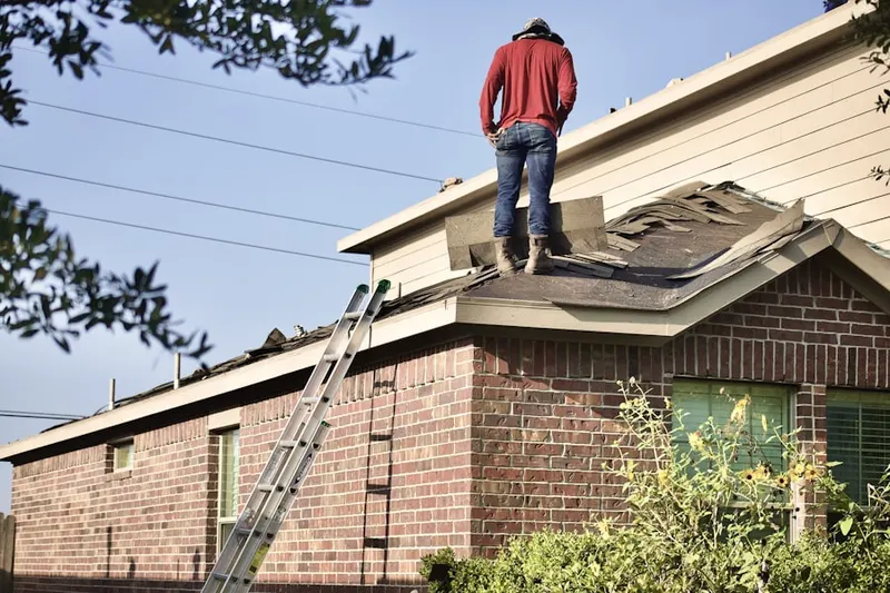 Professional roofer working on a residential roof in Grieder
